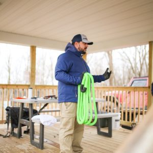 A man holding recovery Rope and talking the class