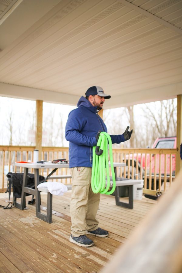 A man holding cable and talking