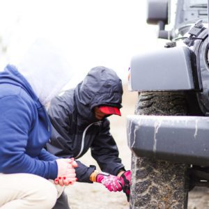 Two people working on a tire