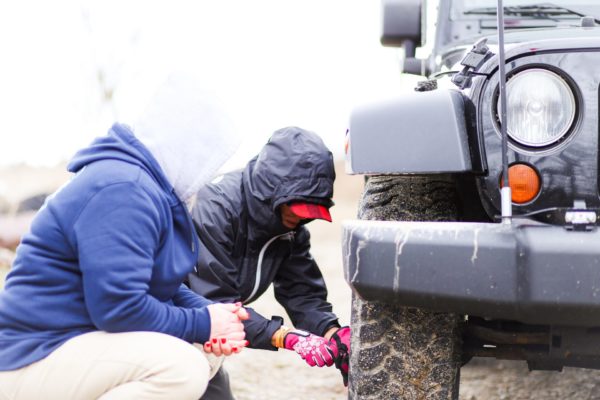 Two people working on a tire