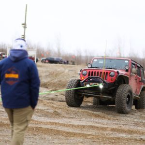 Jeep getting pulled out of a dirt pit