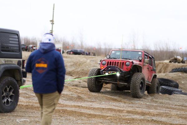 Jeep getting pulled out of a dirt pit